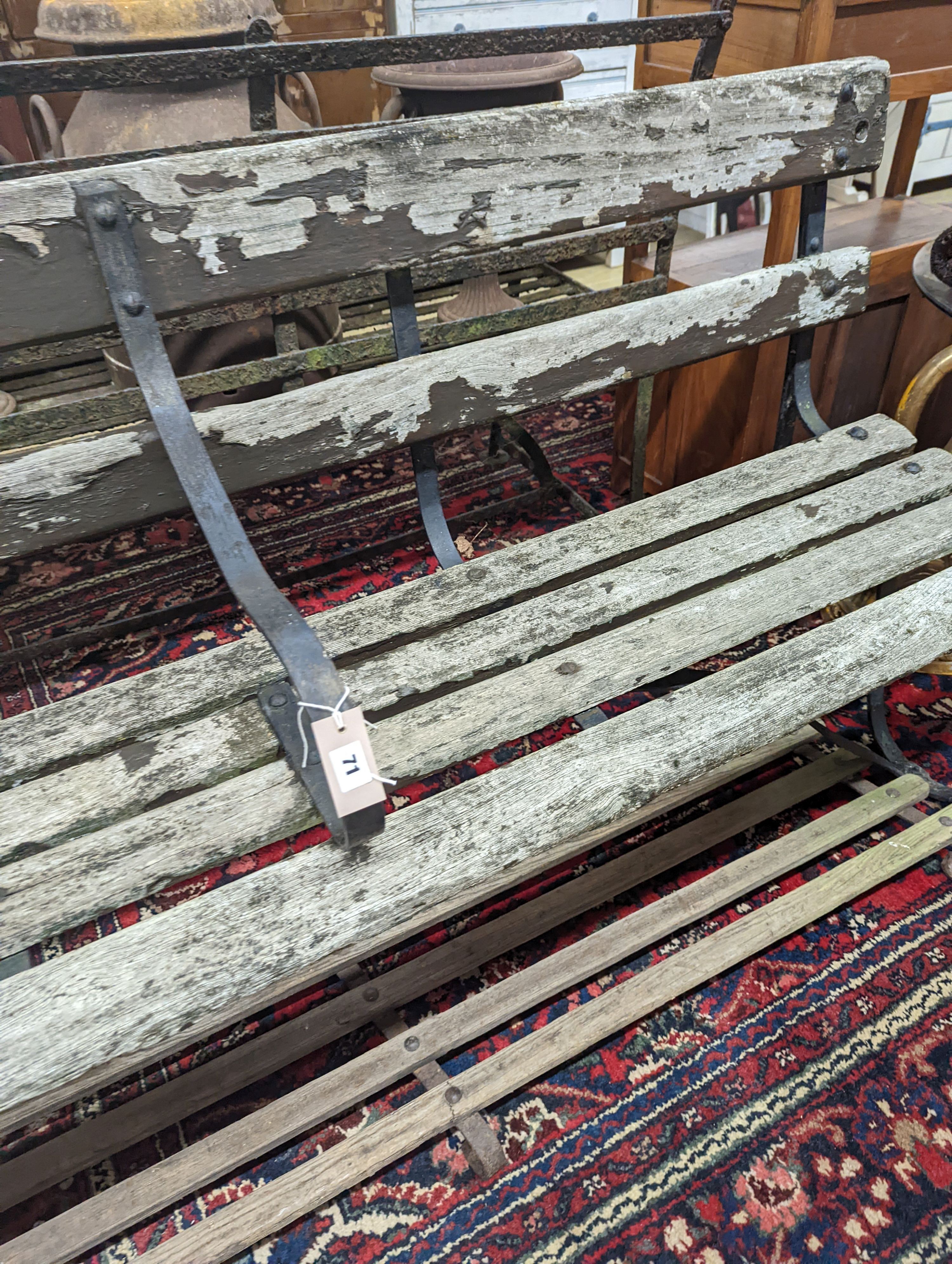 A 19th century wrought iron slatted garden bench with footrest, bench length 182cm, depth 45cm, height 85cm